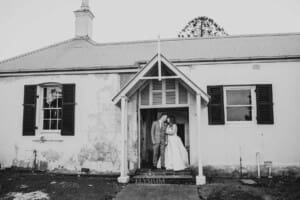 Gledswood wedding - bride and groom stand in the homestead doorway