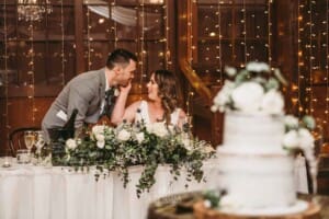 Gledswood wedding - newlyweds sit at the bridal table during the reception