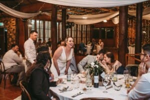 Gledswood wedding - bride and groom visit guests table during the reception