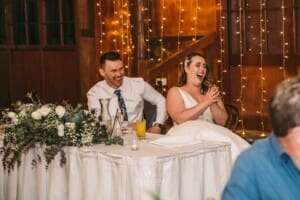 Gledswood wedding - bride and groom laugh during the speeches