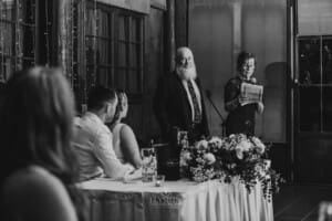 Gledswood wedding - bride and groom listen to his parents make their speech