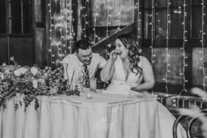 Gledswood wedding - bride and groom laugh at the speeches during the reception