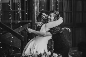 Gledswood wedding - bride hugs the groom's mother after her speech