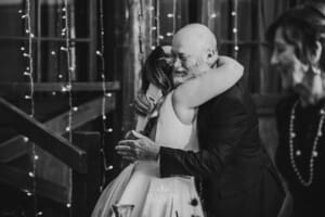 Gledswood wedding - bride hugs the groom's after after his speech