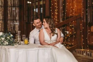 Gledswood wedding - bride and groom hug as they listen to speeches at the reception