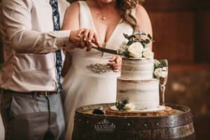 Gledswood wedding - bride and groom cutting their wedding cake