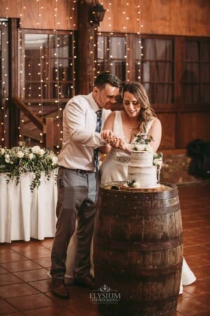 Gledswood wedding - bride and groom cutting their wedding cake at the reception