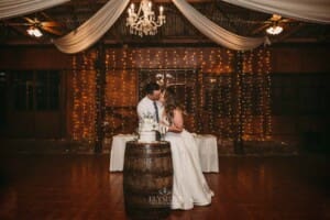 Gledswood wedding - bride and groom kiss after cutting their wedding cake