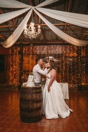 Gledswood wedding - bride and groom make a toast after cutting their wedding cake
