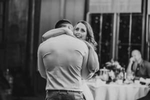 Gledswood wedding - the bride and groom hug as they share their first dance