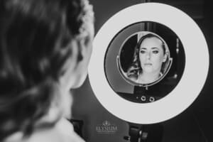 Gledswood Wedding - bride has a final look in the mirror before the ceremony