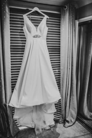 Gledswood Wedding - bridal gown hangs in a window