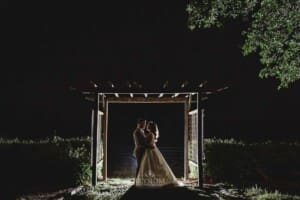Gledswood wedding - night time shot of a couple under an arbour