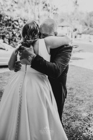 Gledswood Wedding - bride's father gets emotional as he hugs his daughter