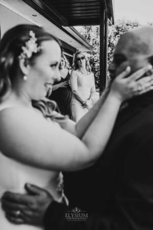 Gledswood Wedding - bride wipes tears away as her dad hugs her