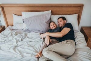 Newborn session - a dad tickles his little boy