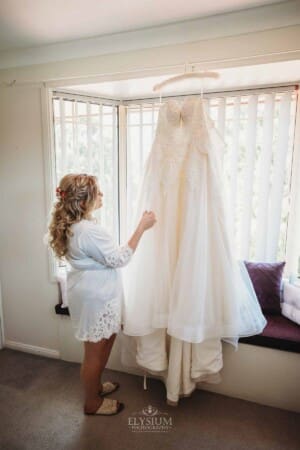 Gledswood Wedding Photo - Bride inspecting her wedding gown