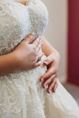 Gledswood Wedding Photo - Brides hands touching the wedding dress