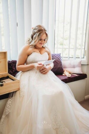 Gledswood Wedding Photo - bride reads her letter from the groom