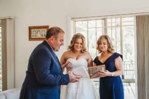 Gledswood Wedding Photo - bride hands her parents wedding gifts