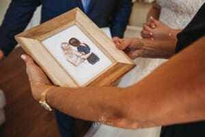 Gledswood Wedding Photo - bride hands her parents wedding gifts