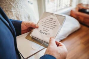 Gledswood Wedding Photo - bride hands her parents wedding gifts