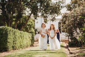 Gledswood Wedding Photo - flower girls walk down the aisle to the ceremony