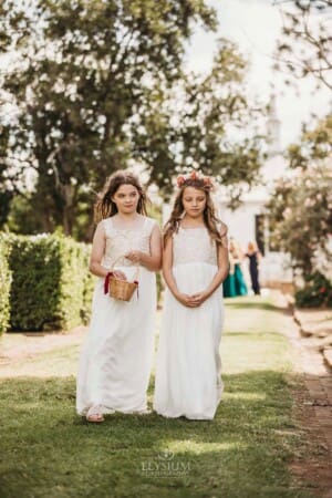 Gledswood Wedding Photo - flower girls walk down the aisle to the ceremony
