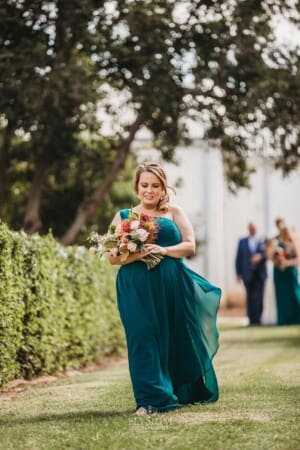 Gledswood Wedding Photo - bridesmaid walks down the aisle to the ceremony