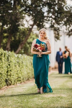 Gledswood Wedding Photo - bridesmaid walks down the aisle to the ceremony