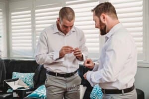 Gledswood Wedding Photo - Groomsman helps the groom with his cufflinks