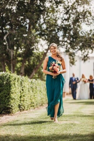 Gledswood Wedding Photo - bridesmaid walks down the aisle to the ceremony