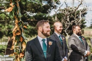 Gledswood Wedding Photo - groom watches his bride walk down the aisle