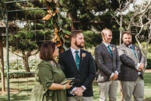 Gledswood Wedding Photo - groom watches his bride walk down the aisle