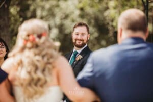 Gledswood Wedding Photo - groom watches his bride walk down the aisle