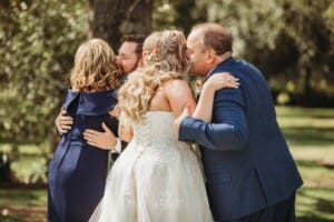 Gledswood Wedding Photo - bride kisses her dad as the ceremony starts