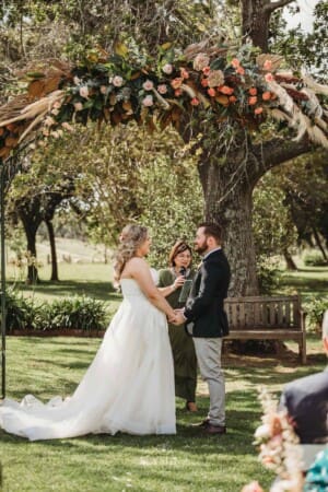 Gledswood Wedding Photo - bride and groom hold hands during the ceremony