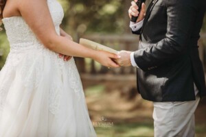 Gledswood Wedding Photo - bride and groom hold hands during the ceremony