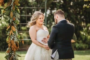 Gledswood Wedding Photo - bride and groom hold hands during the ceremony