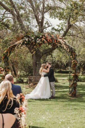 Gledswood Wedding Photo - bride and groom share their first kiss
