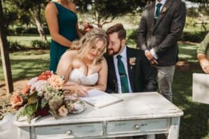 Gledswood Wedding Photo - bride and groom sign the marriage certificate