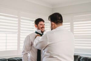 Gledswood Wedding Photo - Groomsman helps with the ties