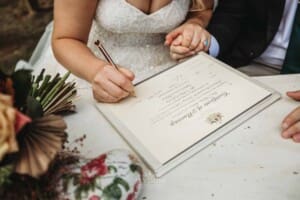 Gledswood Wedding Photo - bride and groom sign the marriage certificate