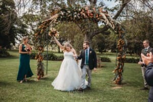 Gledswood Wedding Photo - bride does a fist pump as they are announced