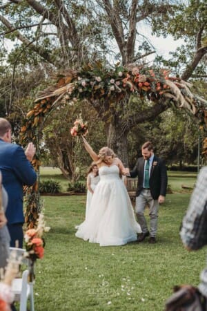 Gledswood Wedding Photo - bride does a fist pump as they are announced