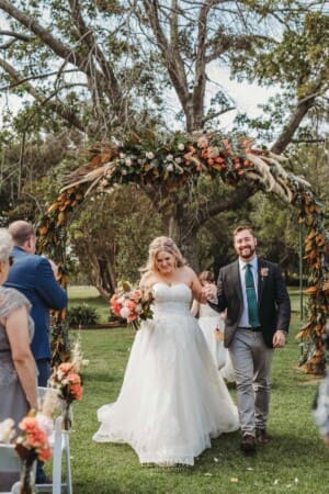 Gledswood Wedding Photo - bride and groom walk down the aisle after the ceremony