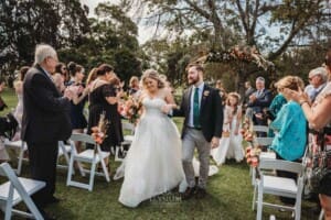 Gledswood Wedding Photo - bride and groom walk down the aisle after the ceremony