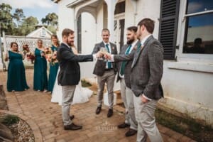 Gledswood Wedding Photo - the groom and groomsmen toast champagne glasses