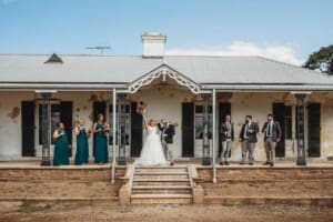Gledswood Wedding Photo - bridal party cheer on the homestead steps