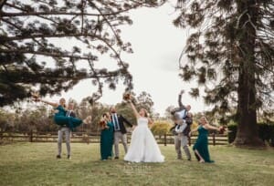 Gledswood Wedding Photo - the bridal party play games on the homestead lawn